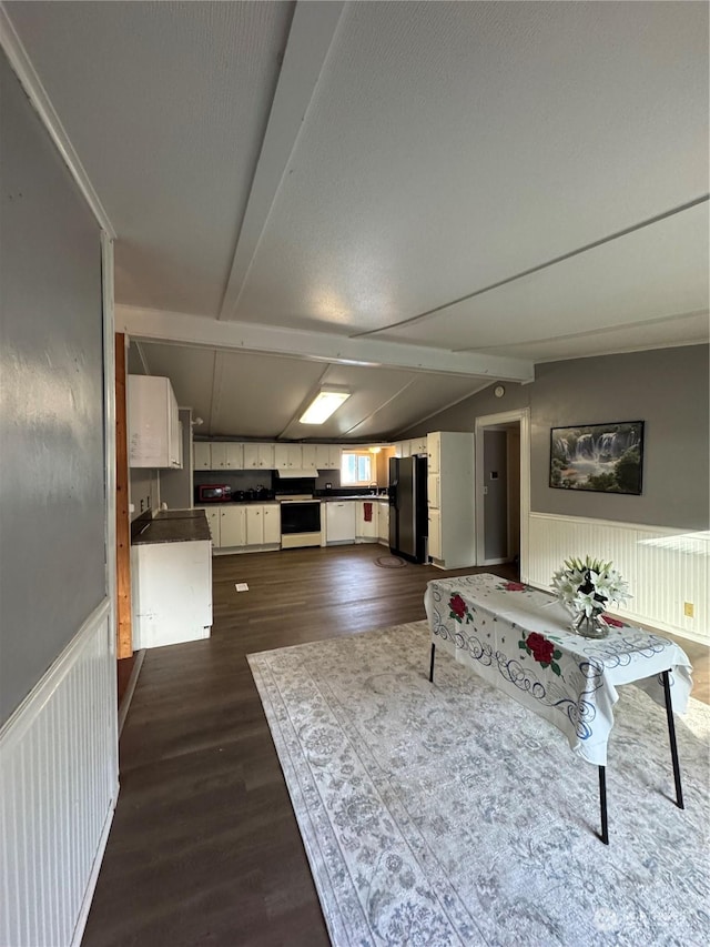 living room with dark wood-type flooring and lofted ceiling with beams