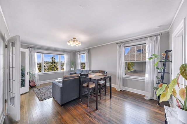 dining room featuring french doors, dark hardwood / wood-style flooring, plenty of natural light, and crown molding