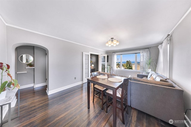 dining area with dark wood-type flooring, french doors, and crown molding