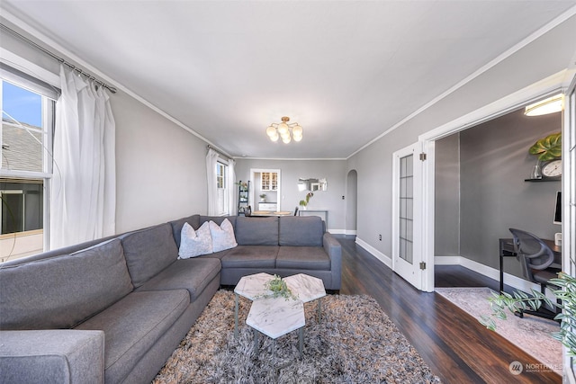 living room featuring ornamental molding, a chandelier, and dark hardwood / wood-style floors