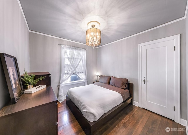 bedroom featuring an inviting chandelier, ornamental molding, and dark wood-type flooring