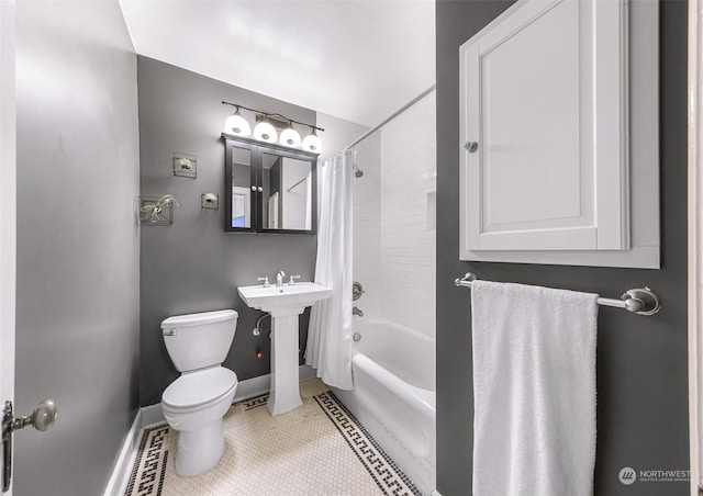 bathroom featuring tile patterned flooring, shower / bath combination with curtain, and toilet