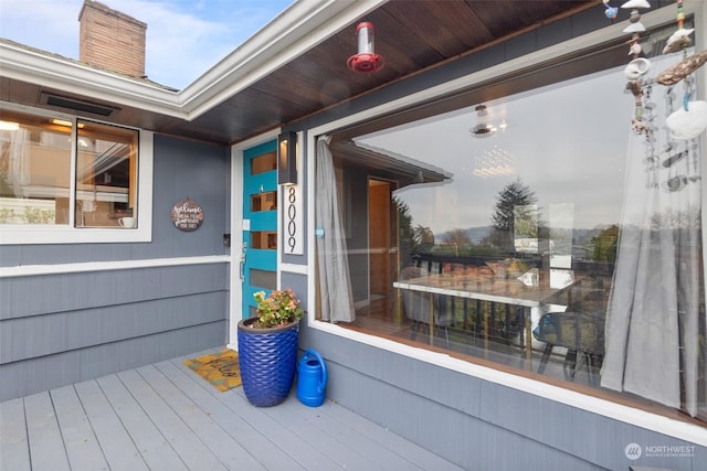 entrance to property featuring a wooden deck