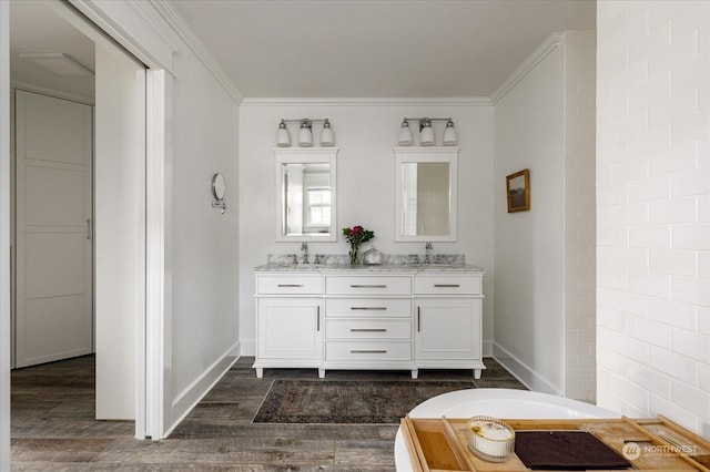 bathroom featuring ornamental molding, hardwood / wood-style flooring, and vanity