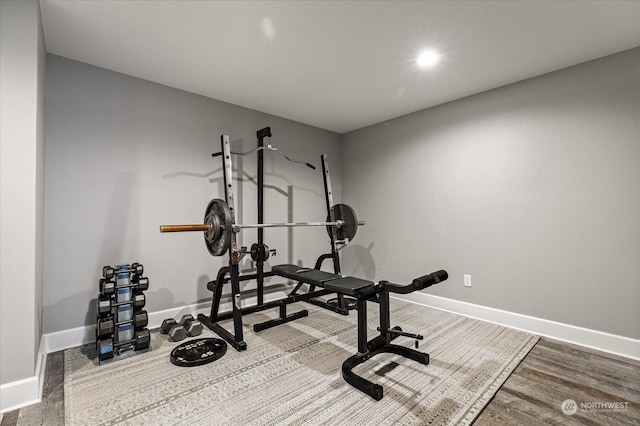 exercise room with wood-type flooring