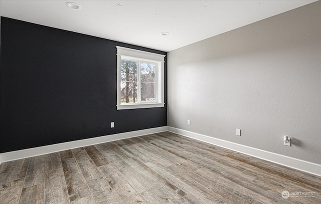 unfurnished room with hardwood / wood-style flooring