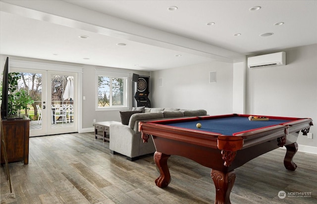 rec room featuring hardwood / wood-style flooring, a wall mounted AC, pool table, and french doors