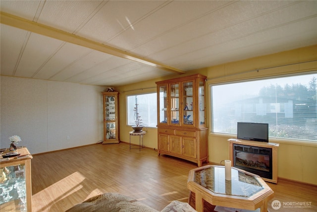 unfurnished living room featuring baseboards and light wood-style floors