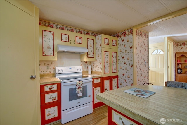 kitchen with under cabinet range hood, light wood-style floors, light countertops, white electric range oven, and wallpapered walls