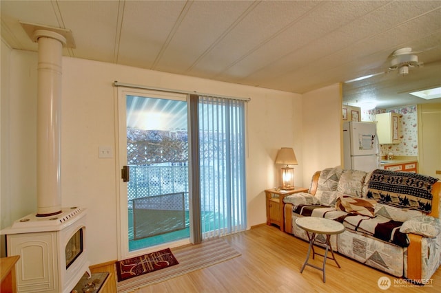 living area featuring a wood stove and light wood-style floors