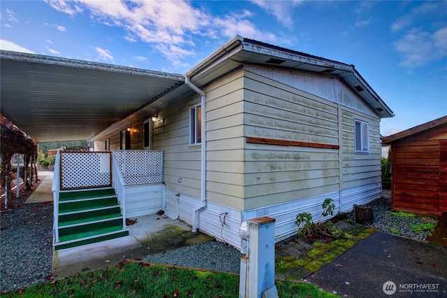 view of side of property featuring covered porch