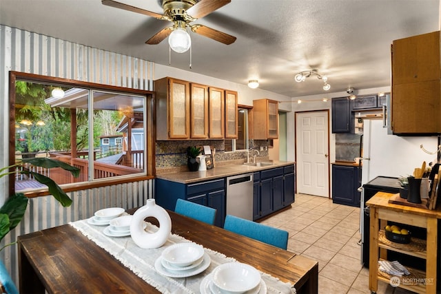 kitchen with dishwasher, light tile patterned floors, decorative backsplash, ceiling fan, and sink