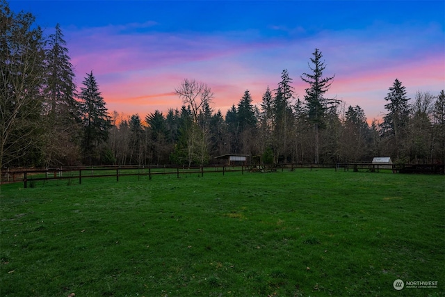 yard at dusk with a rural view