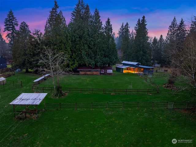 yard at dusk with a rural view