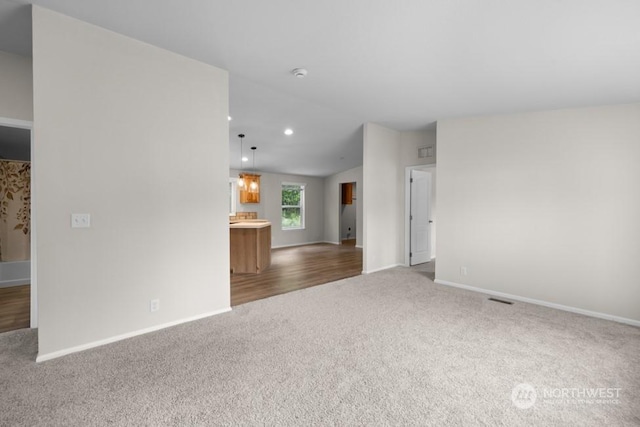 unfurnished living room featuring carpet floors and lofted ceiling