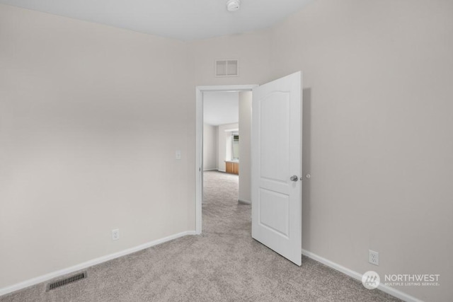 spare room with light colored carpet