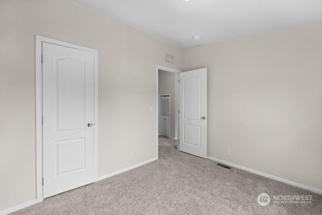 unfurnished bedroom featuring light colored carpet