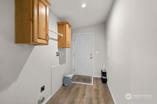 laundry room with cabinets, washer hookup, hookup for an electric dryer, and light hardwood / wood-style flooring