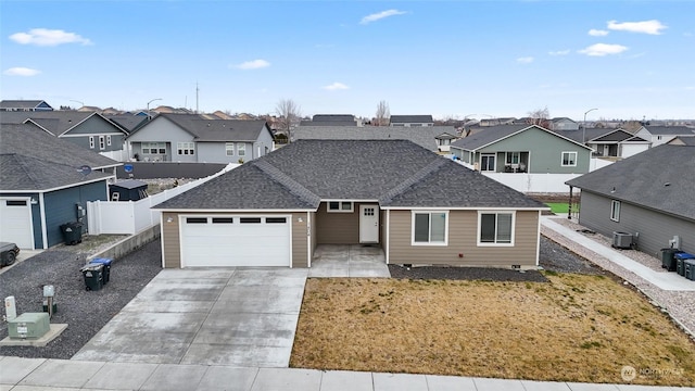 view of front property featuring a front yard, a garage, and central air condition unit