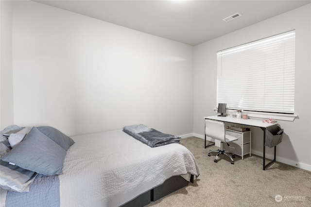 bedroom featuring light carpet