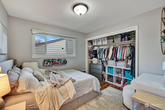 bedroom featuring wood-type flooring and a closet