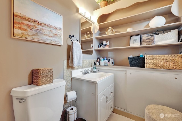 bathroom featuring toilet and vanity