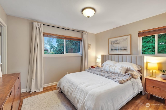 bedroom with dark hardwood / wood-style floors