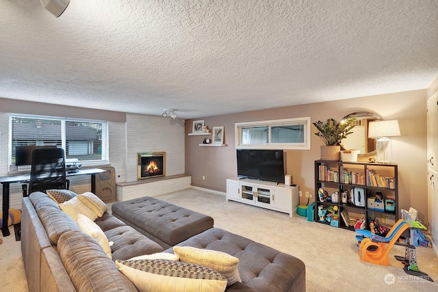 living room with a textured ceiling, a brick fireplace, and light carpet