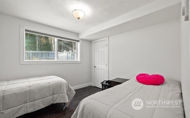 bedroom with dark hardwood / wood-style flooring