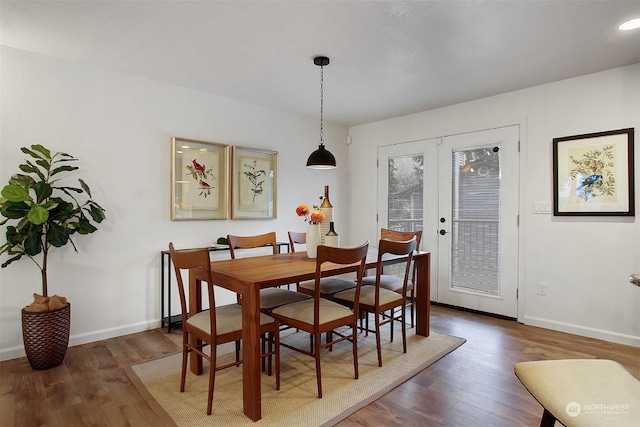 dining area with french doors and dark hardwood / wood-style floors