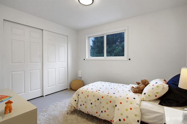 bedroom featuring a closet and light carpet