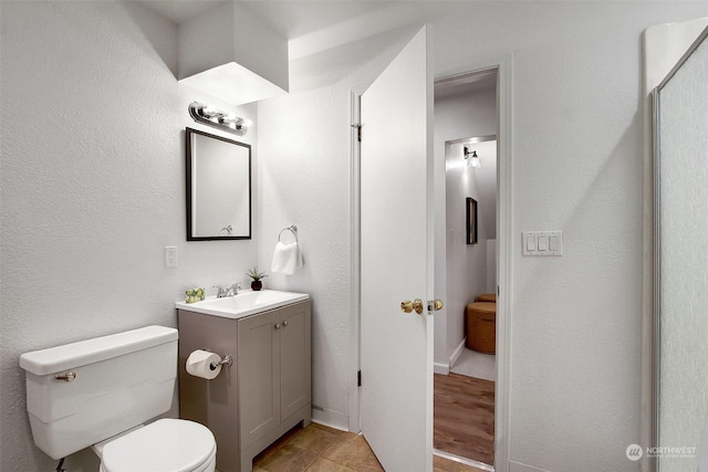 bathroom featuring toilet and vanity