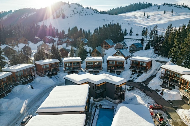 snowy aerial view with a mountain view