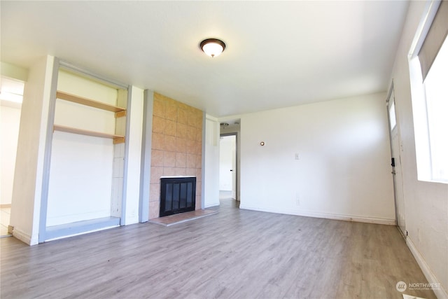 17333 33rd Ave S, Seatac, WA 98188 - unfurnished living room with hardwood / wood-style floors and a tile fireplace