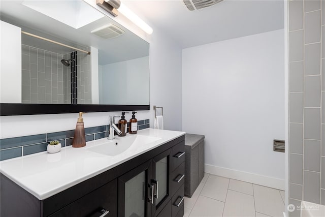 bathroom with vanity, tile patterned floors, and a tile shower