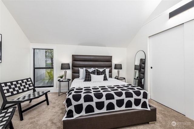 carpeted bedroom with vaulted ceiling