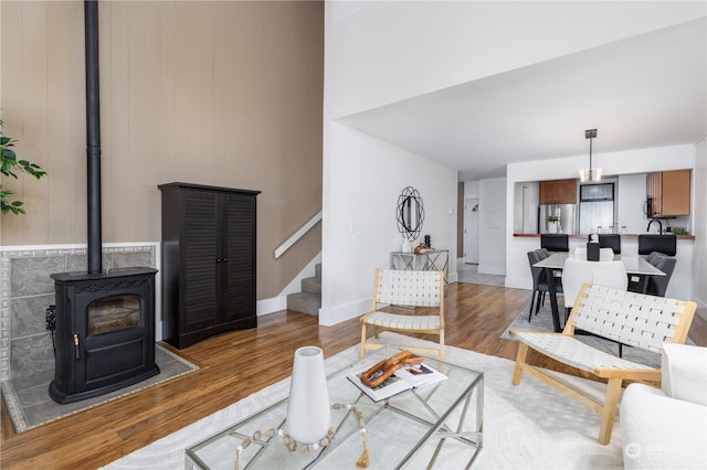 living room with a wood stove and hardwood / wood-style floors