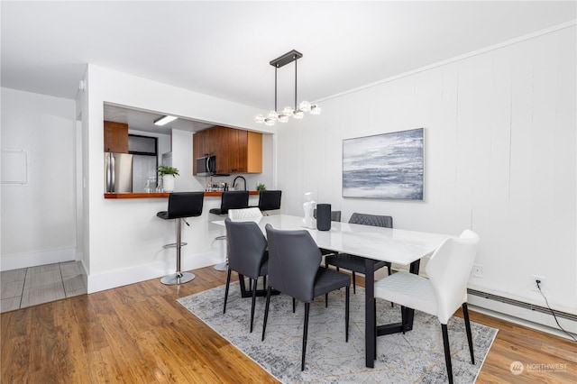 dining area featuring a chandelier and light hardwood / wood-style floors