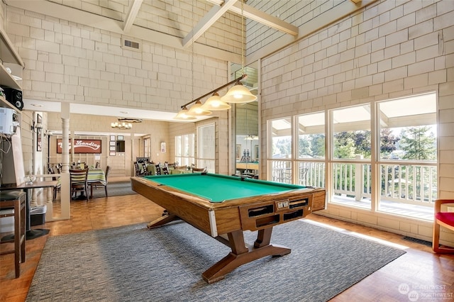 rec room featuring a notable chandelier, parquet floors, a towering ceiling, billiards, and beamed ceiling