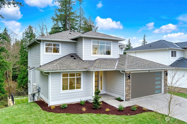 front facade featuring a front lawn and a garage