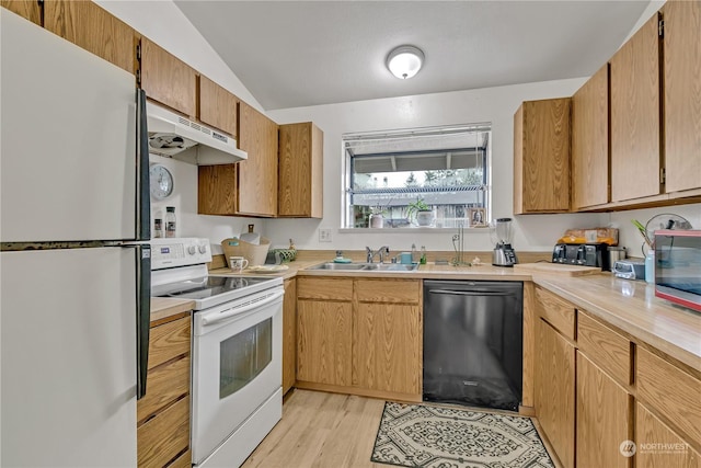 kitchen featuring sink, white appliances, lofted ceiling, and light wood-type flooring