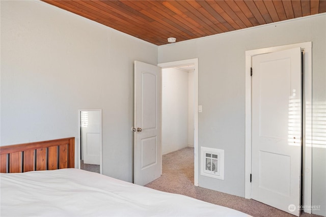 carpeted bedroom with wooden ceiling