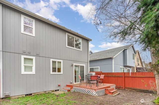 back of house with a wooden deck