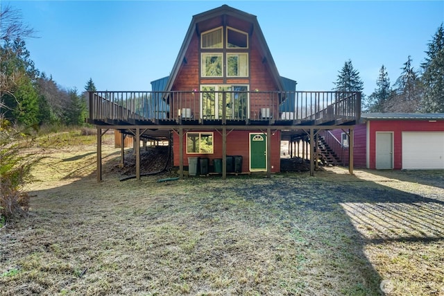 exterior space featuring stairway, a garage, and a deck