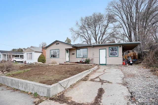 ranch-style home featuring a carport