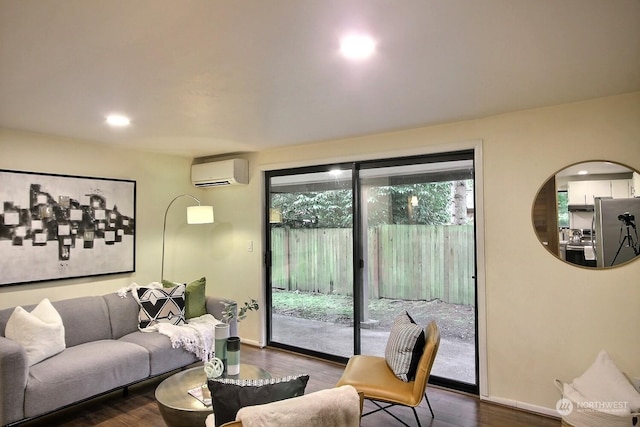 living room with wood-type flooring and a wall mounted air conditioner