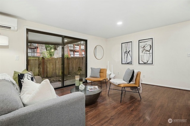 living room featuring dark wood-type flooring and a wall unit AC