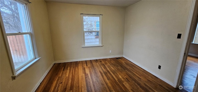 unfurnished room featuring dark hardwood / wood-style flooring