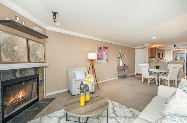 living room with carpet floors, a tiled fireplace, and ornamental molding