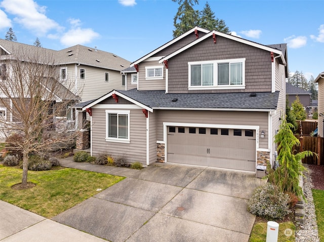 craftsman-style house featuring a front lawn and a garage